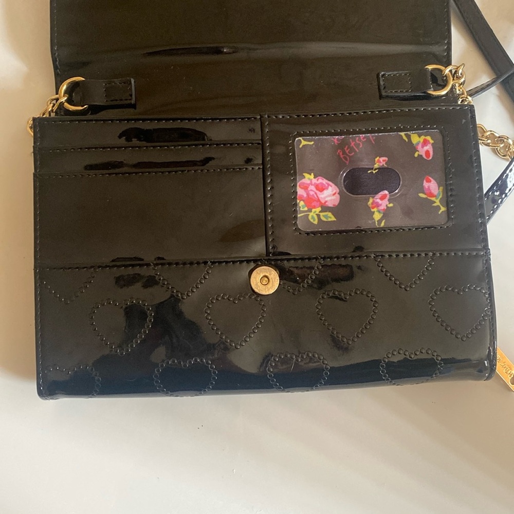 Black Betsey Johnson purse, medium sized, two pocket compartments